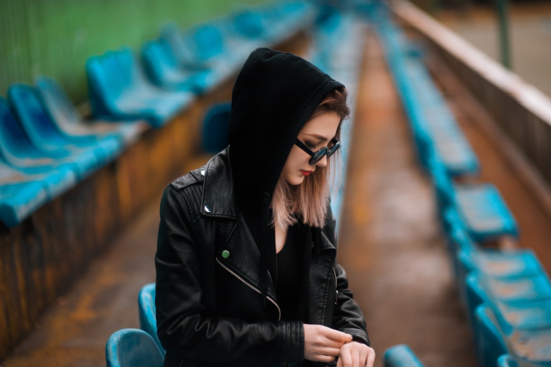 woman sitting on bleachers