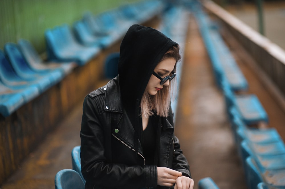 woman sitting on bleachers