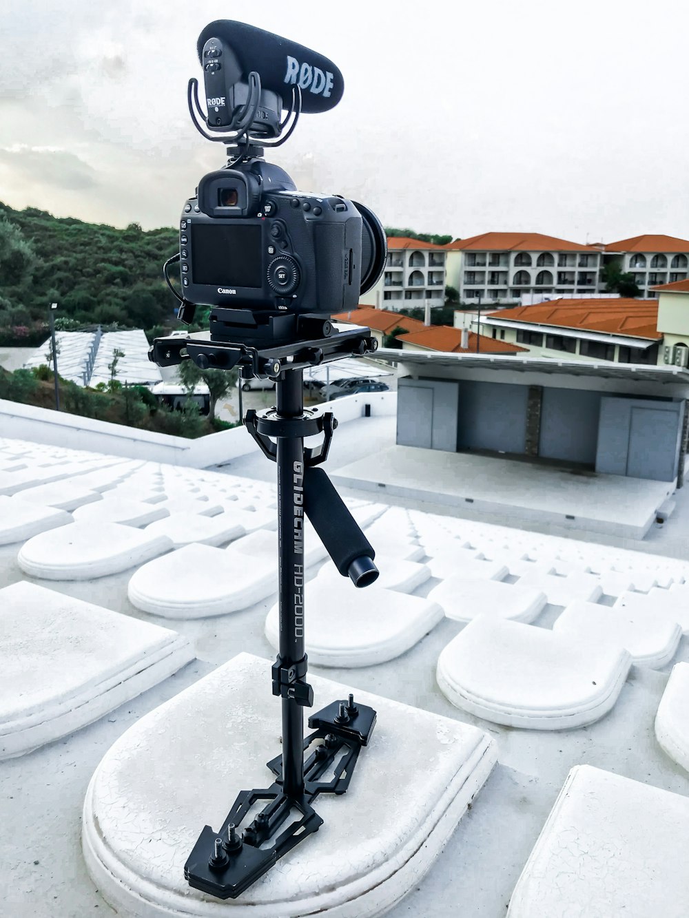 black DSLR camera on tripod standing near stage