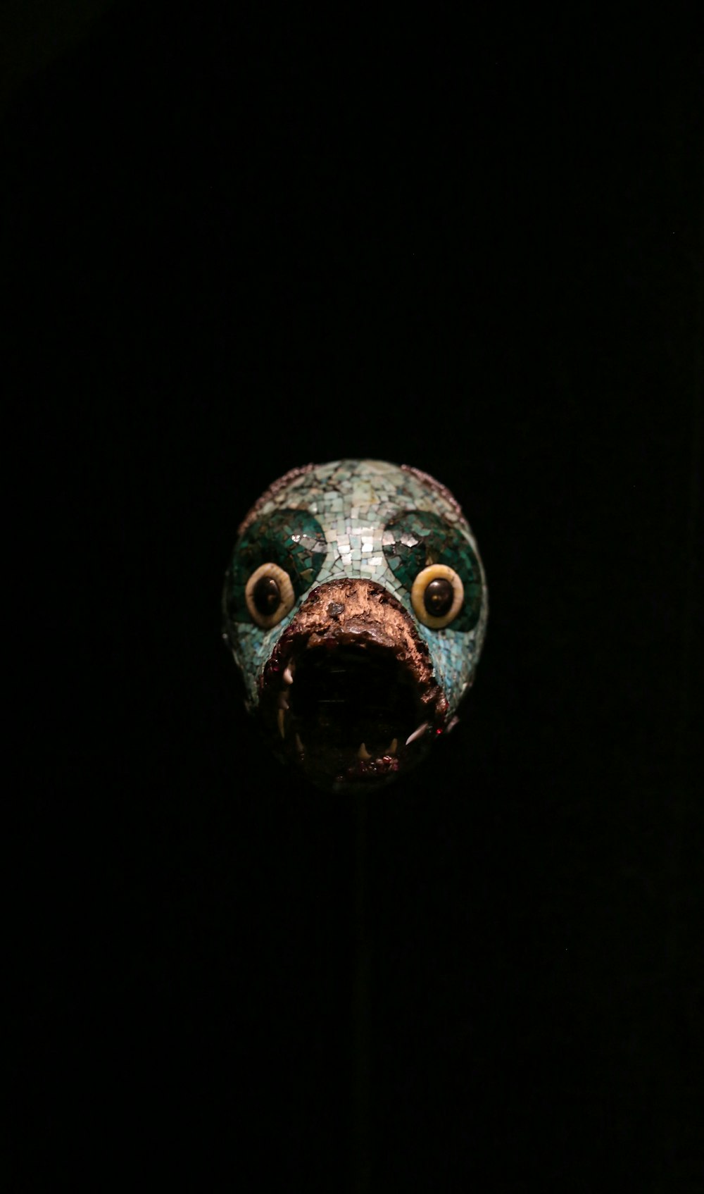 a close up of a mask in the dark