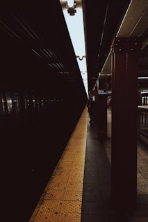 A nighttime shot of New York City’s Penn Station entrance glowing with warm lights and busy commuters.