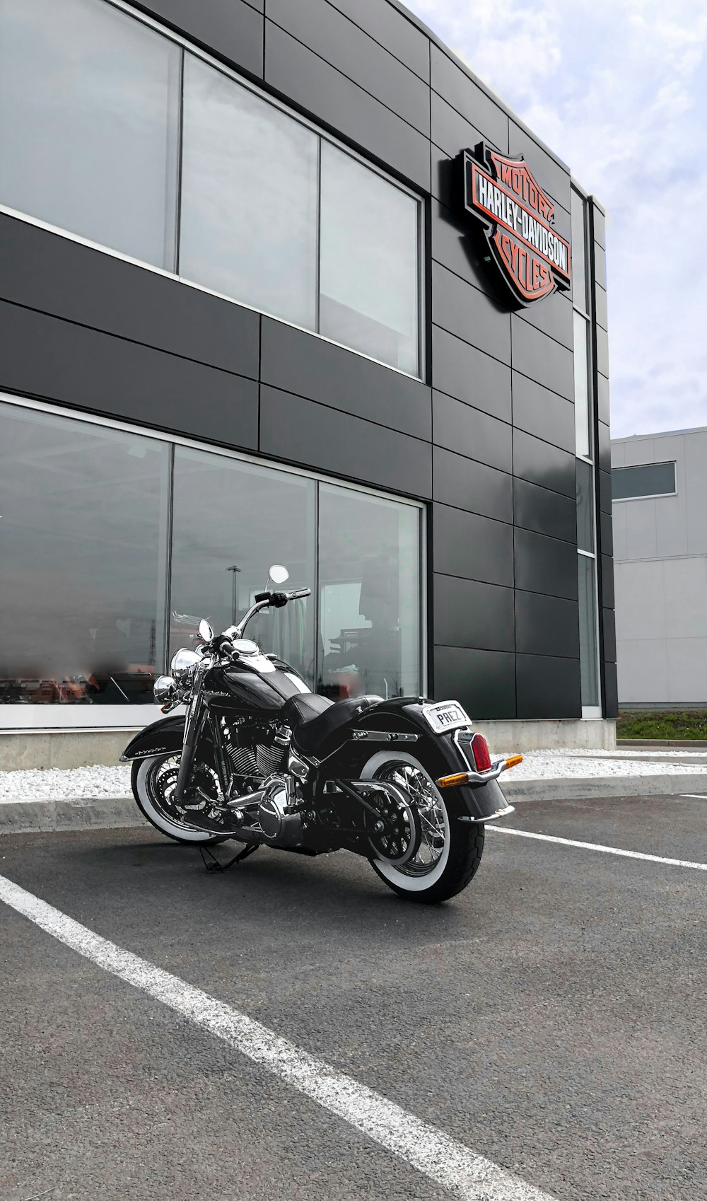 Motocicleta Cruiser negra estacionada al lado de la tienda