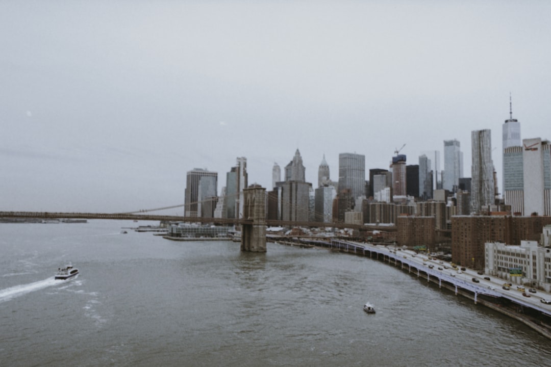 buildings beside body of water under white sky