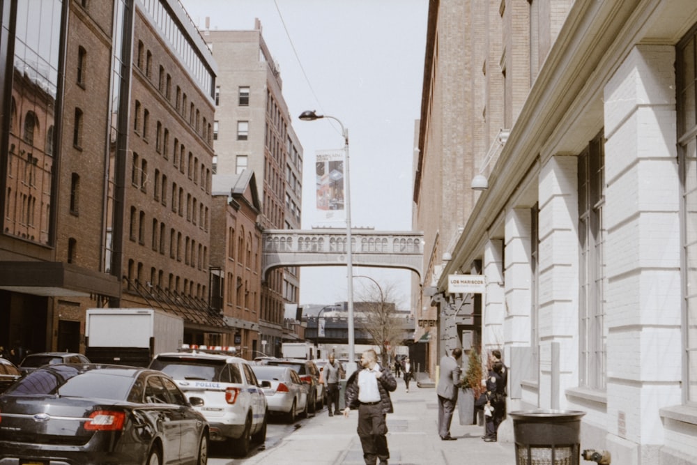 people walking on road sidewalk during daytime