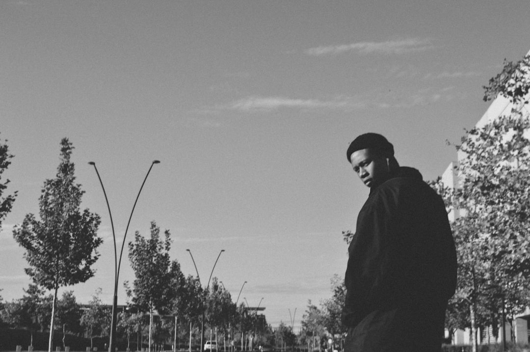 grayscale photo of man in jacket