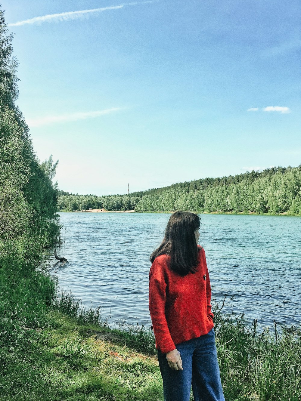 woman standing beside river