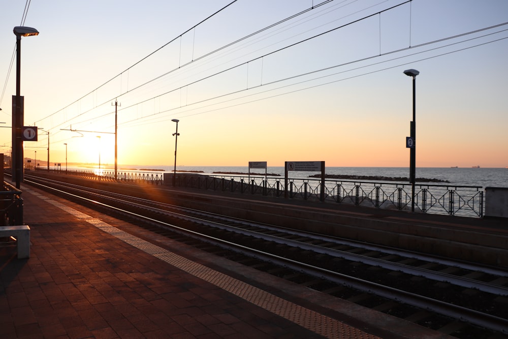 train rail near body of water