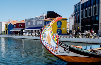 white and brown boat on body of water