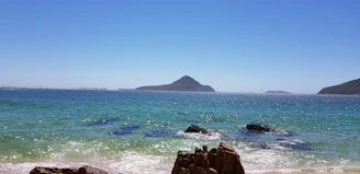 body of water under blue sky