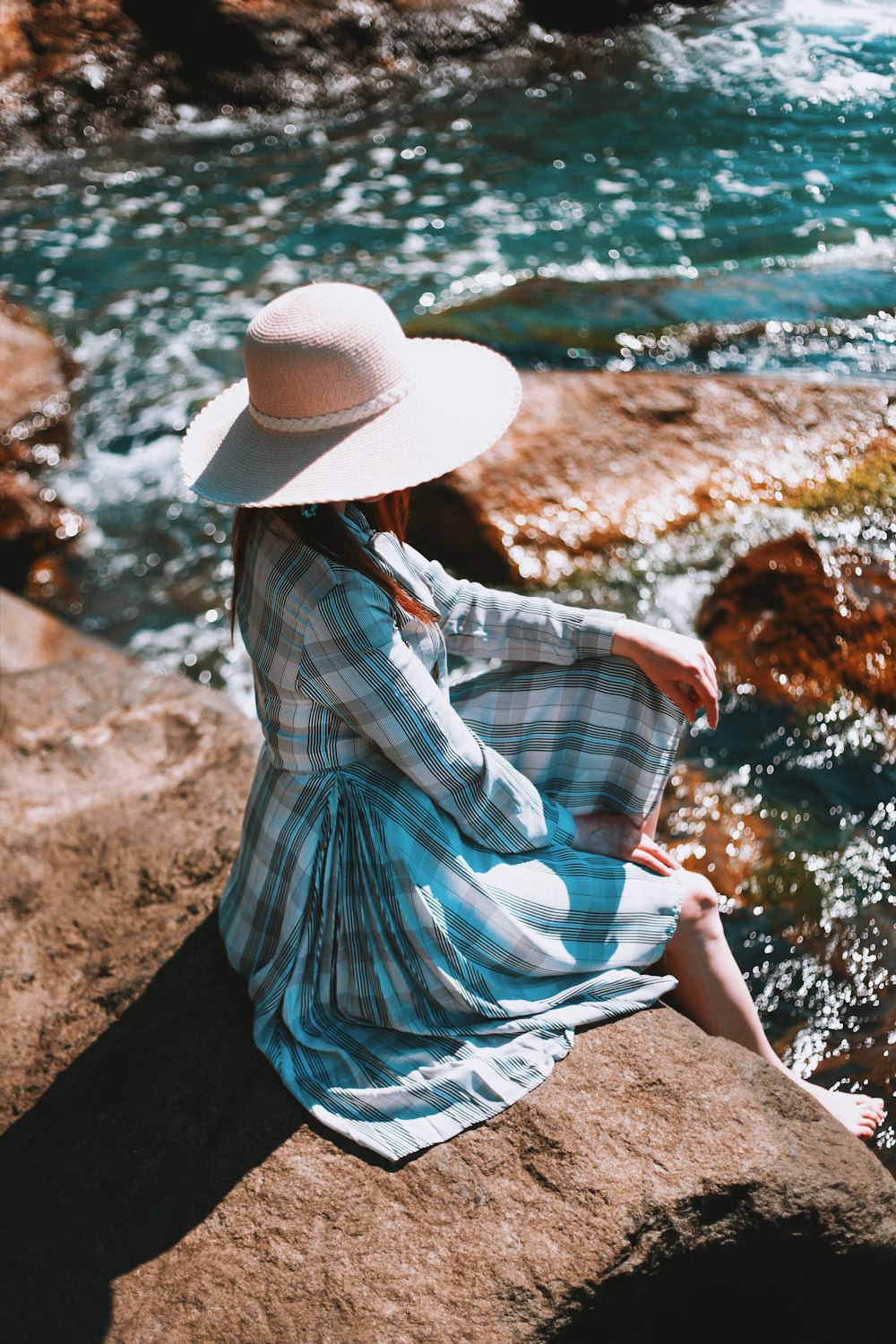 woman sitting on cliff