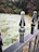 Close-up of textured fencing panel with snow melting at its base in a suburban garden.