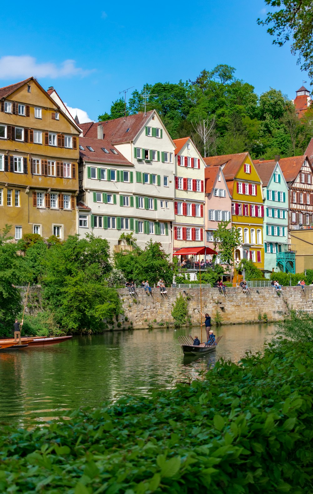 people on boat near houses