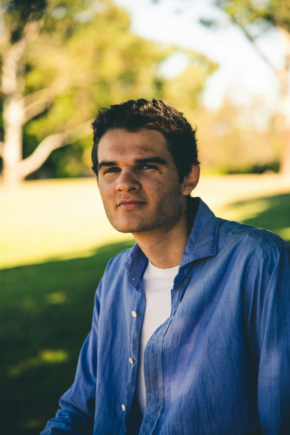 selective focus photography of man wearing blue dress shirt