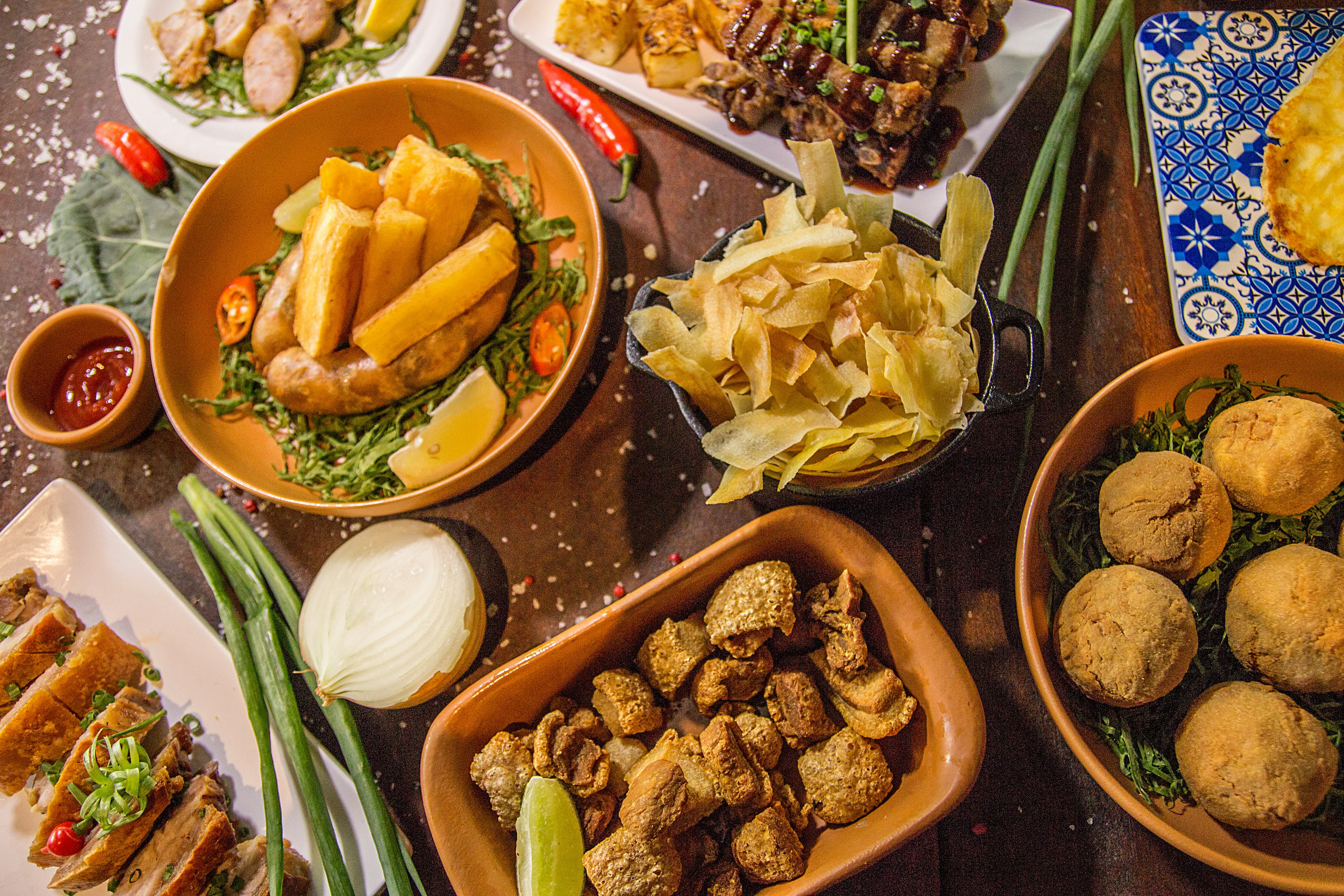 Image of many foods in bowls on a table. Image by Nathaniel Yeo on Unsplash.