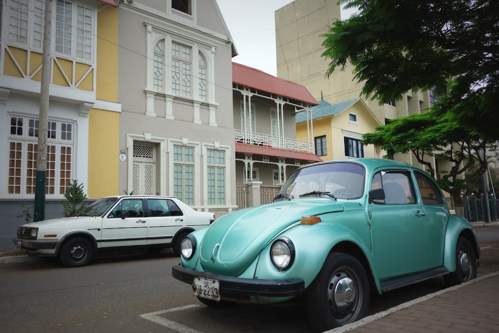 teal Volkswagen Beetle parked outside house