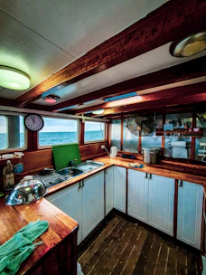 A bright, modern kitchen with ocean-blue accents and wooden details.