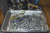 Close-up of an assortment of modern hair styling tools on a countertop.