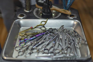 Close-up of shiny scissors and combs on a salon workstation