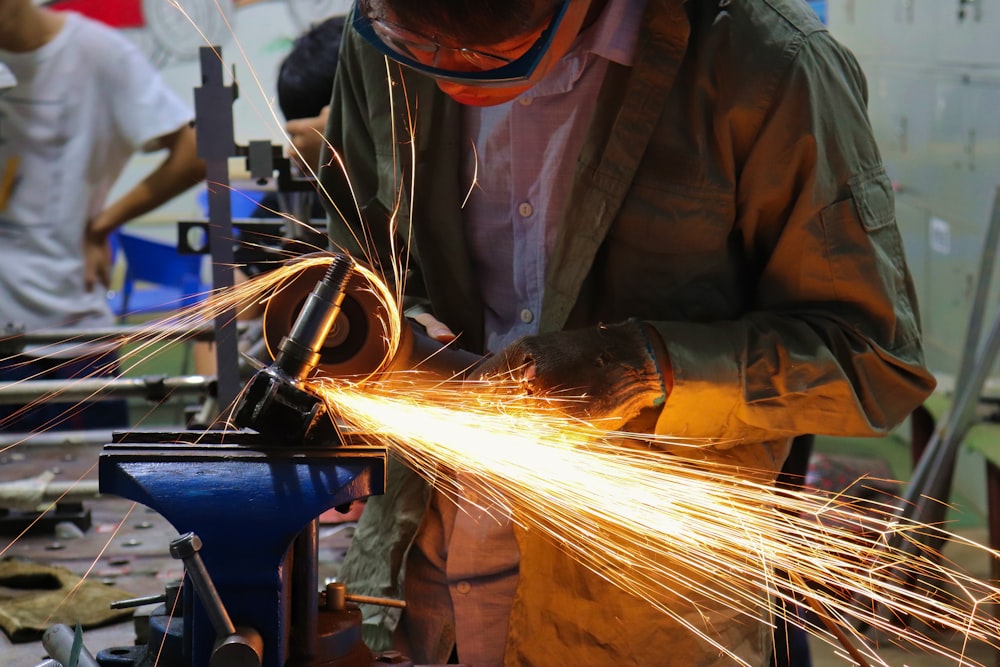 man cutting iron