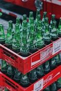 Stacks of vibrant Campa Cola bottles neatly arranged in a retail store aisle.