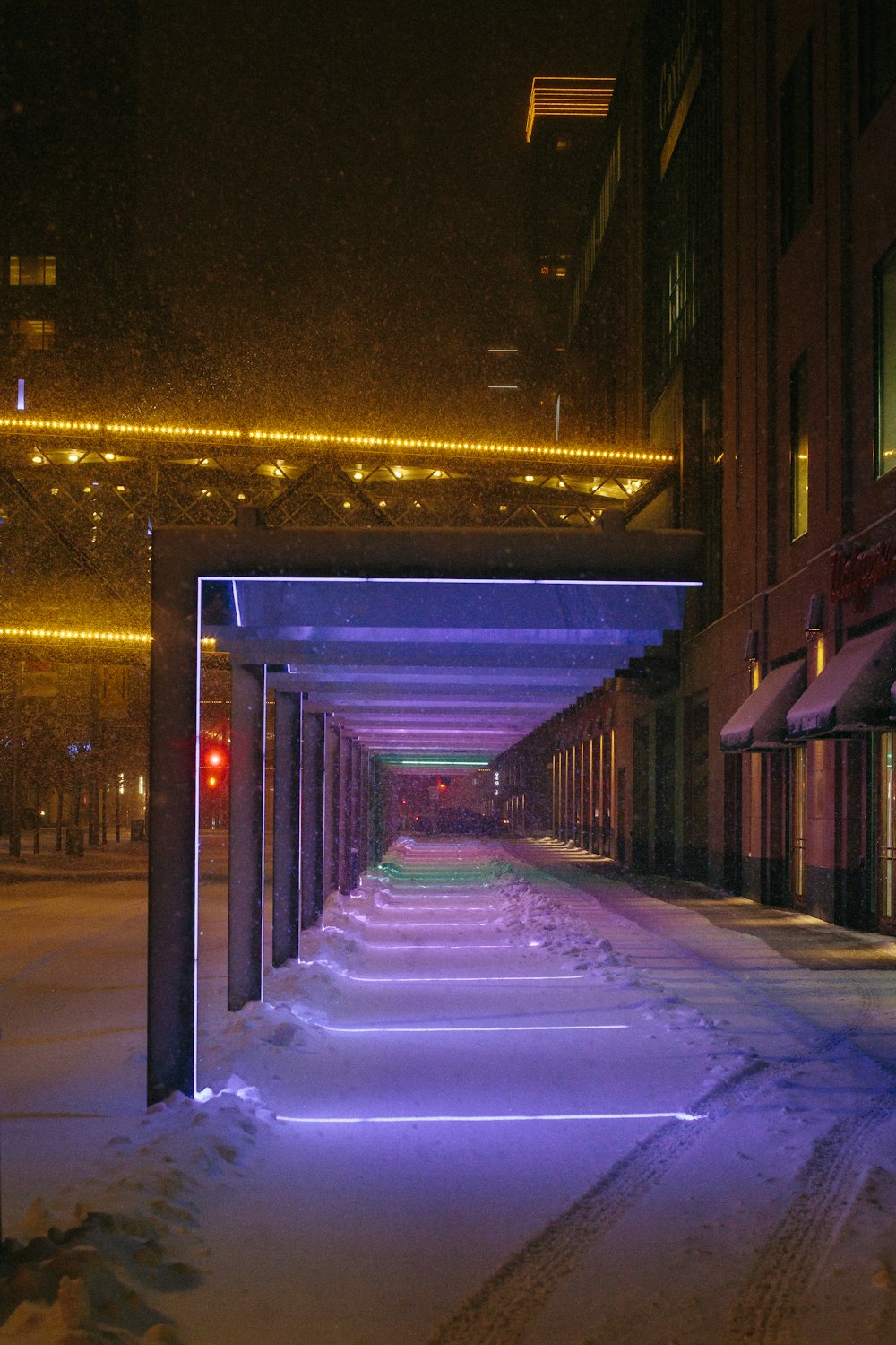 a long row of buildings on a snowy street