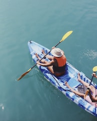 person holding paddle in boat