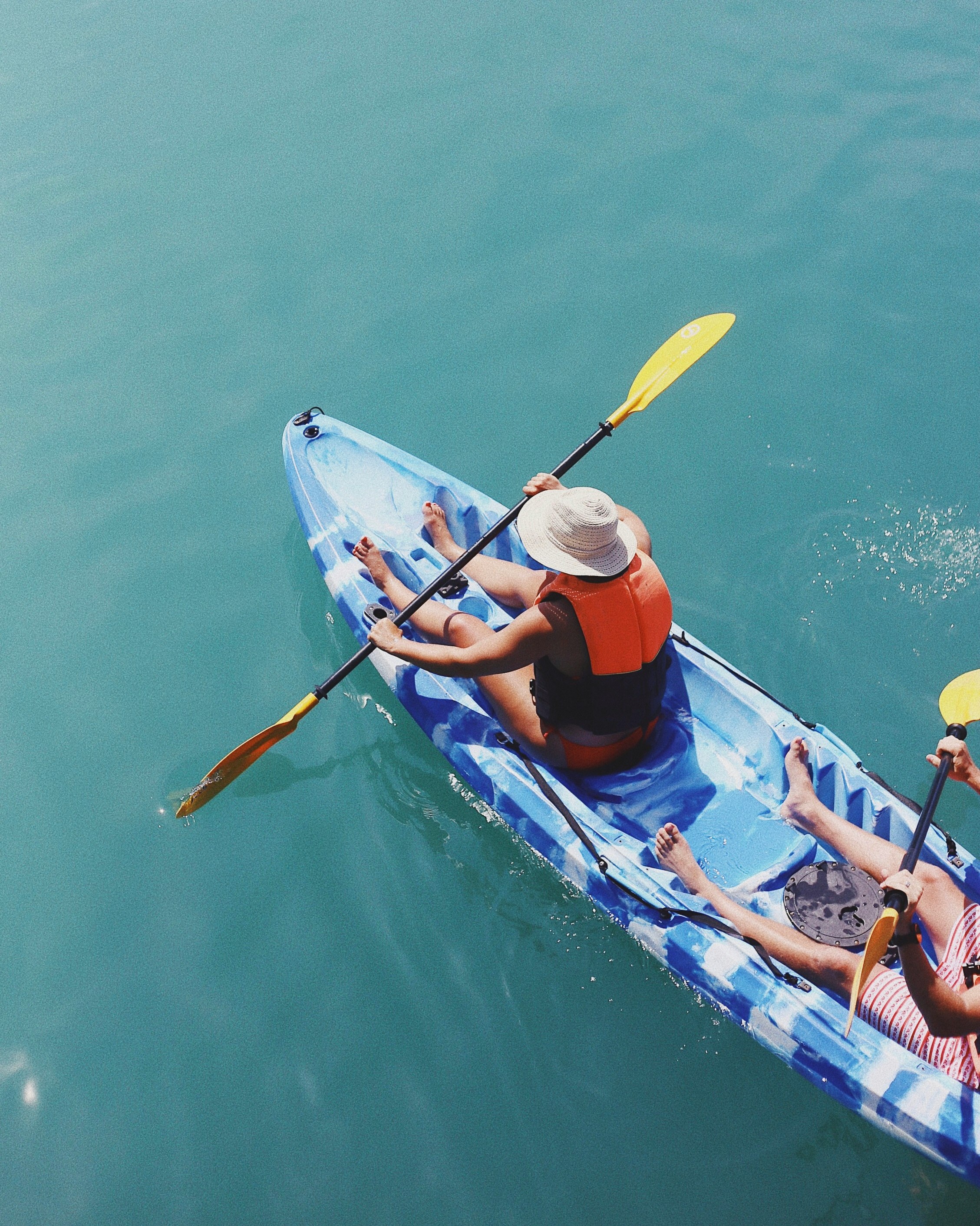 person holding paddle in boat