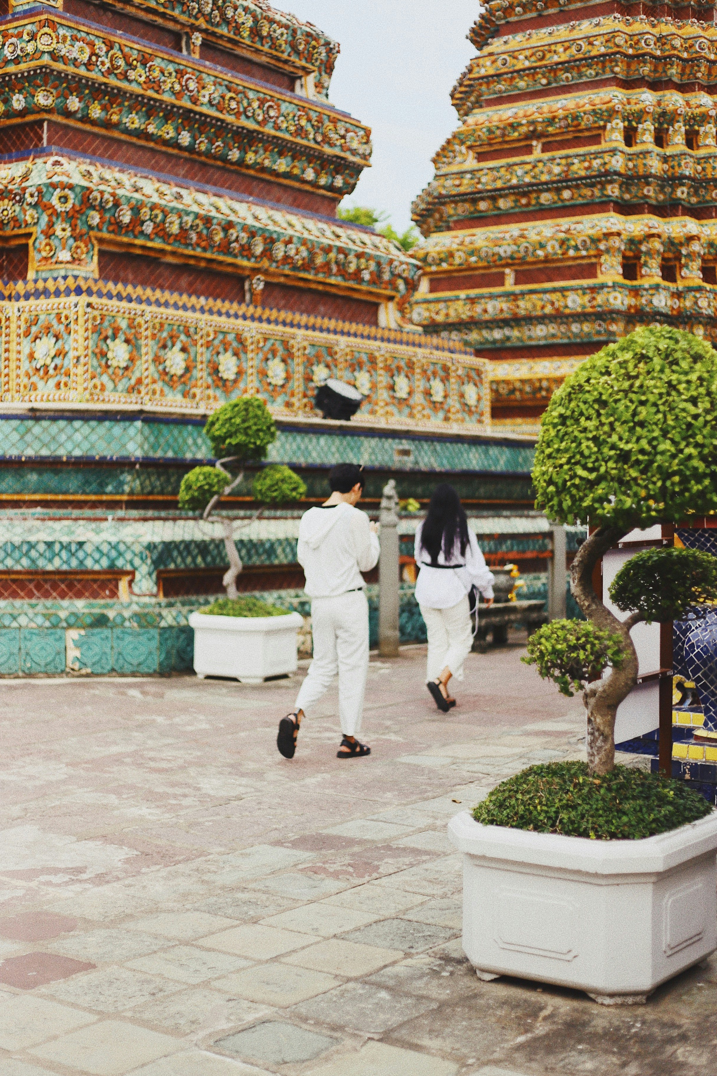 man and woman in white going to temple