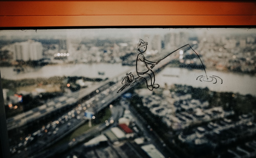 Un dibujo de una persona en un cable sobre una ciudad