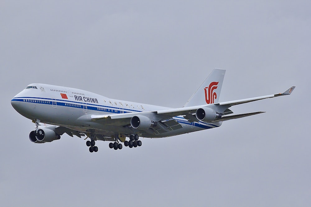 white and blue airplane