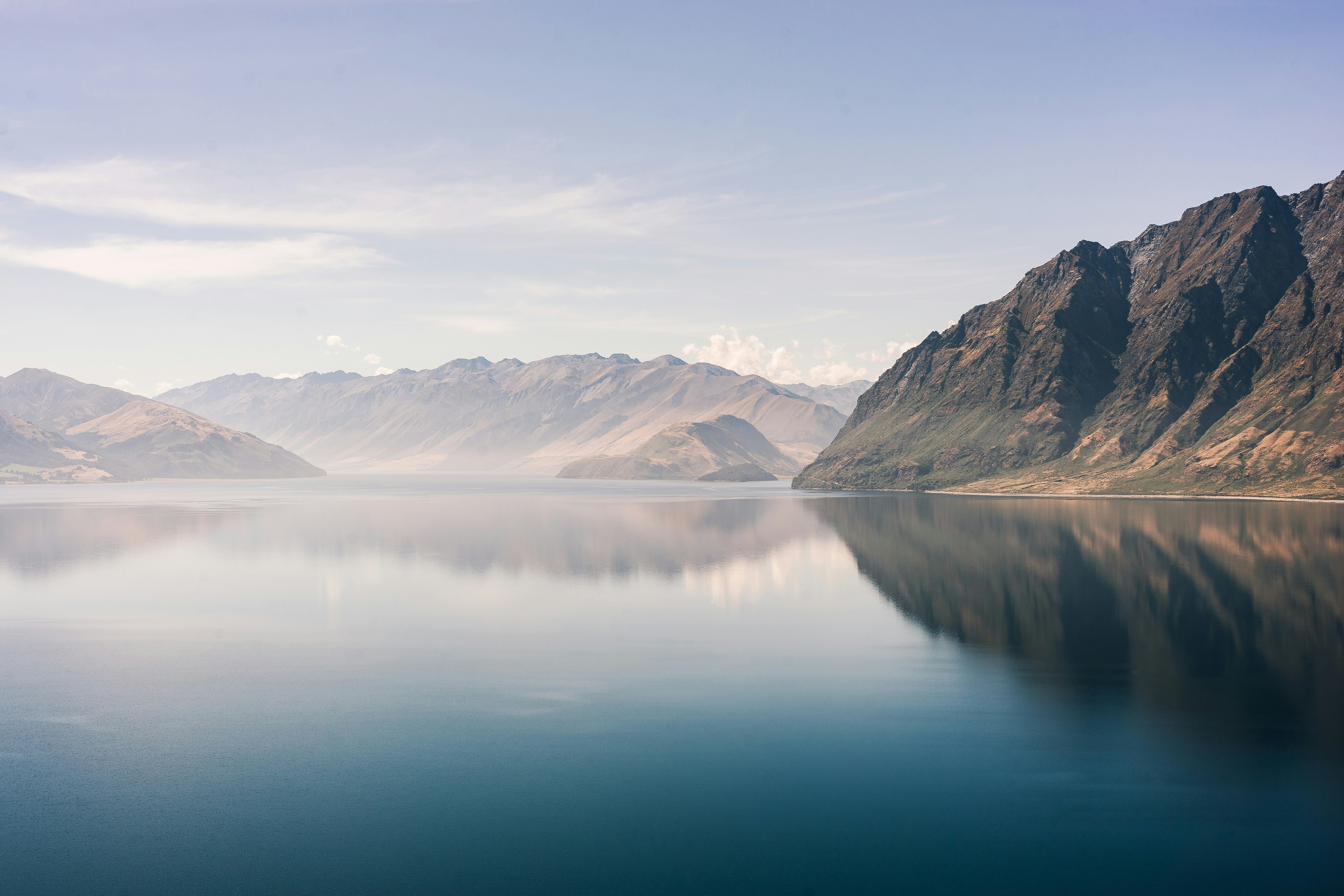 gray mountain near body of water during daytime