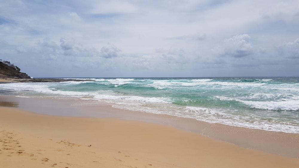 beach line under gray clouds