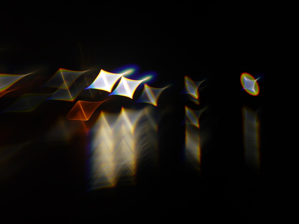 a blurry image of a black background with white and yellow lights