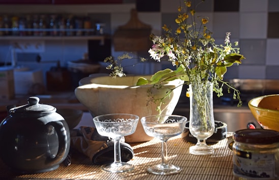 A cozy kitchen scene featuring a wooden countertop with ceramic bowls, sharp knives, and elegant chopsticks neatly arranged.