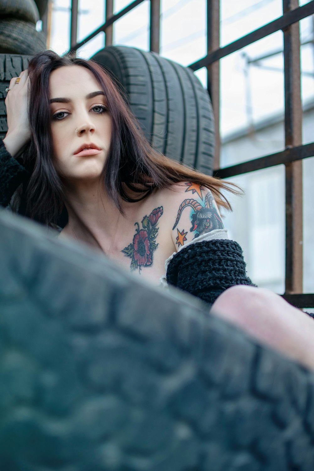 woman sitting near vehicle tire