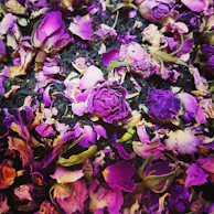 Scented slime in shades of pink and lavender with dried flower petals mixed in.