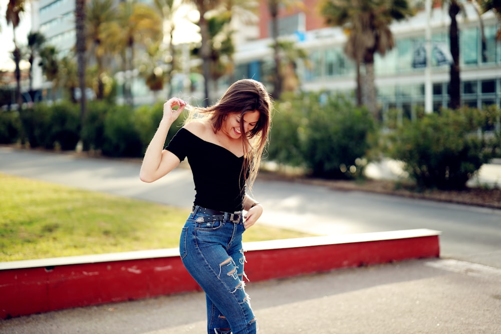 selective focus photography of woman standing near trees