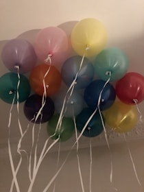 Colorful balloons floating above a table decorated with custom name tags.