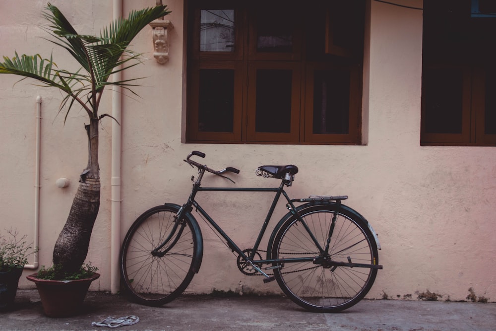 black rigid bicycle on white wall