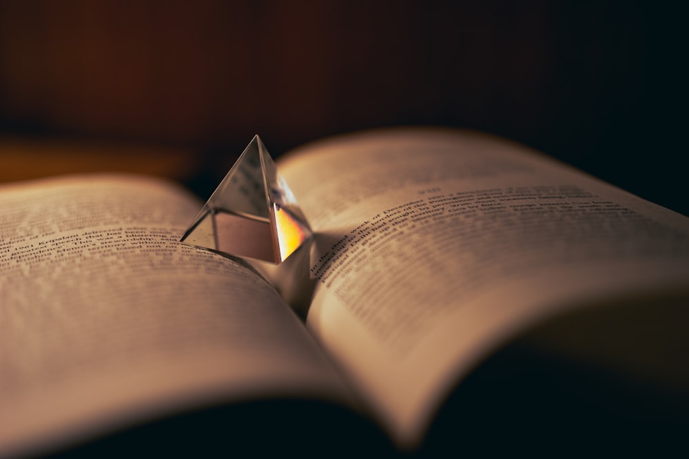 pyramid clear glass decor on opened book