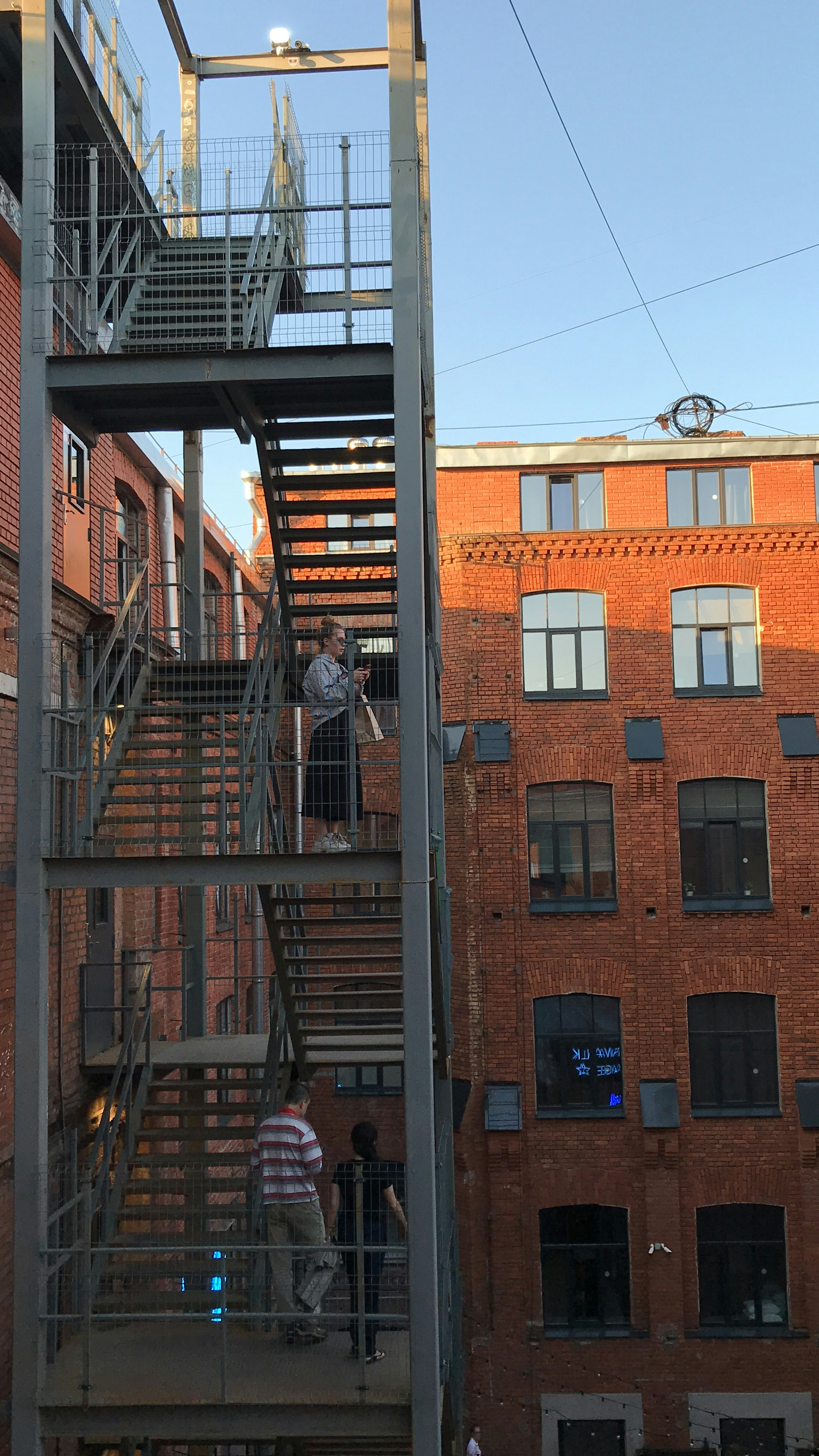 people walking on stairs beside building