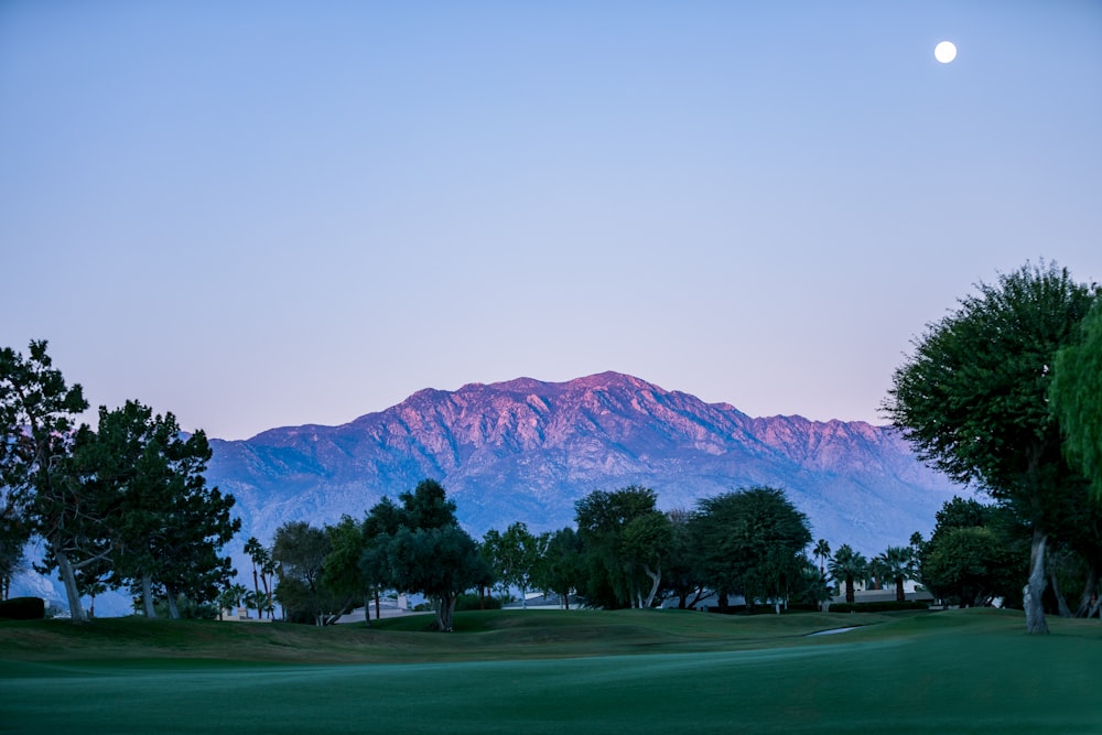 moon above mountain and golf course