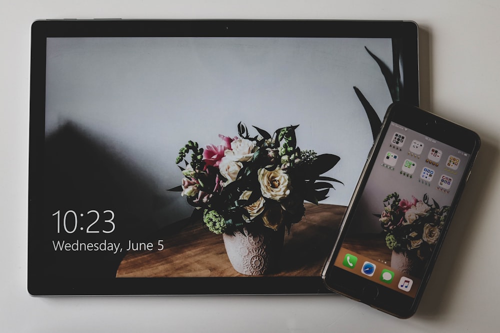 black tablet computer and smartphone turned on