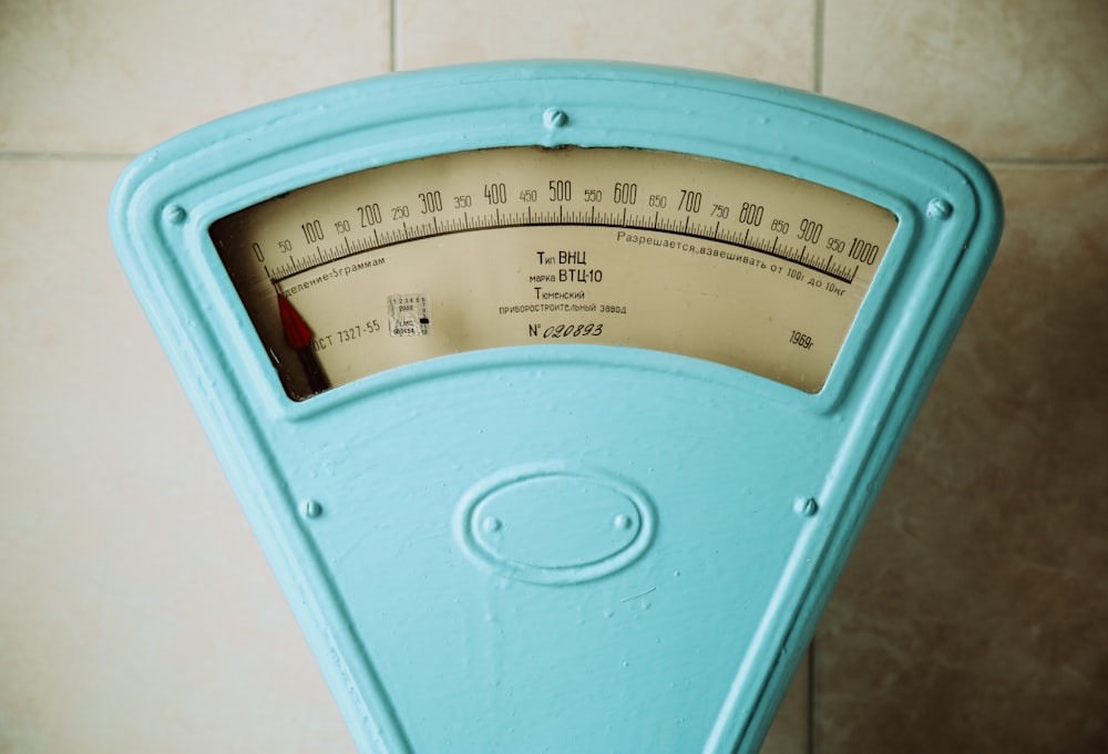 a close up of a meter on a tiled wall