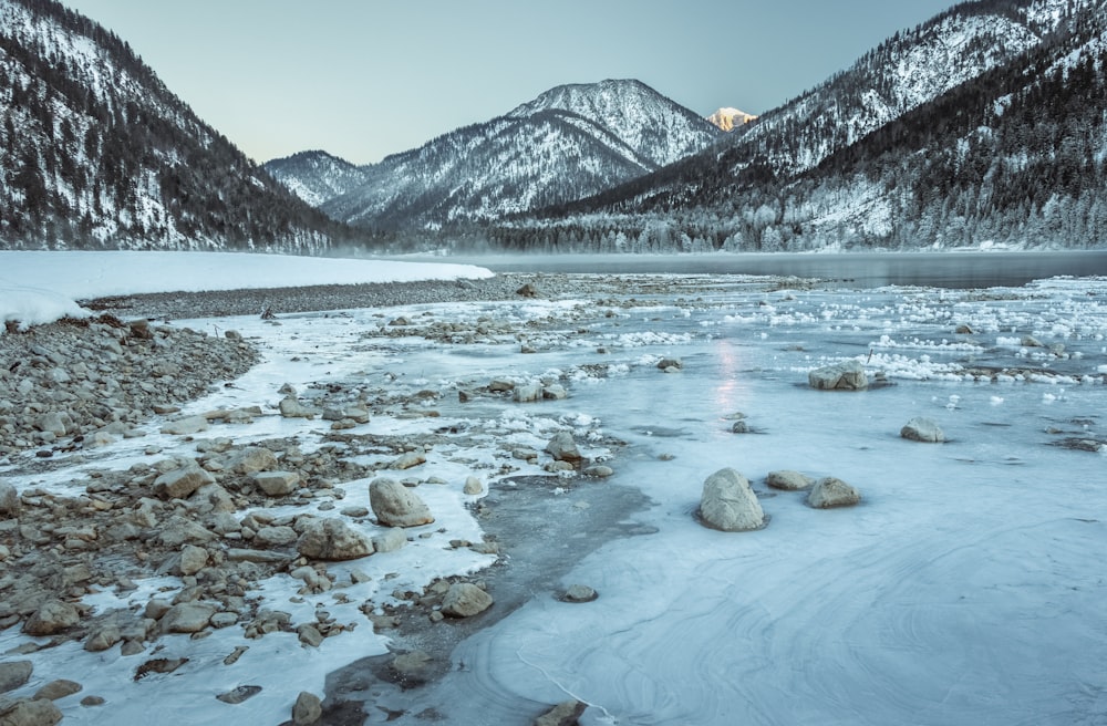 river towards snow capped mountain at daytime