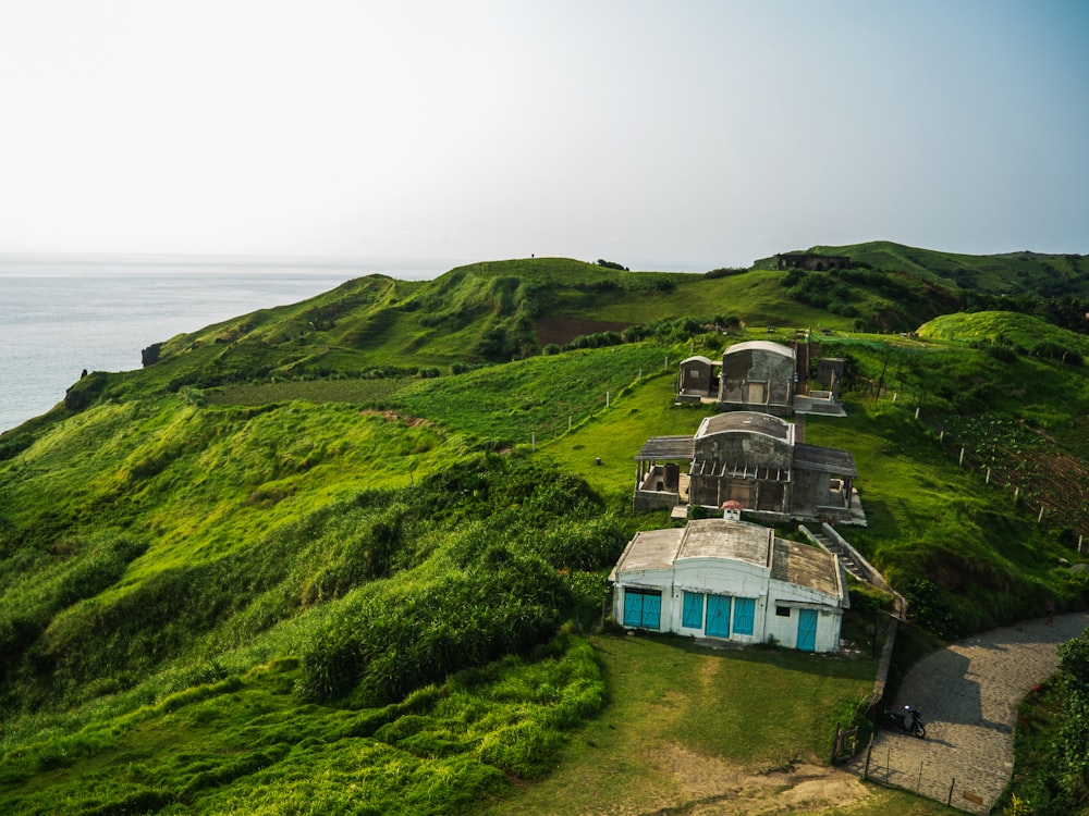 white concrete building on hill