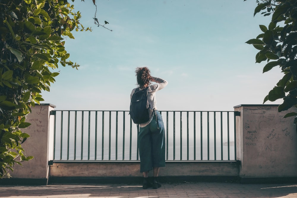 person standing in front of fence