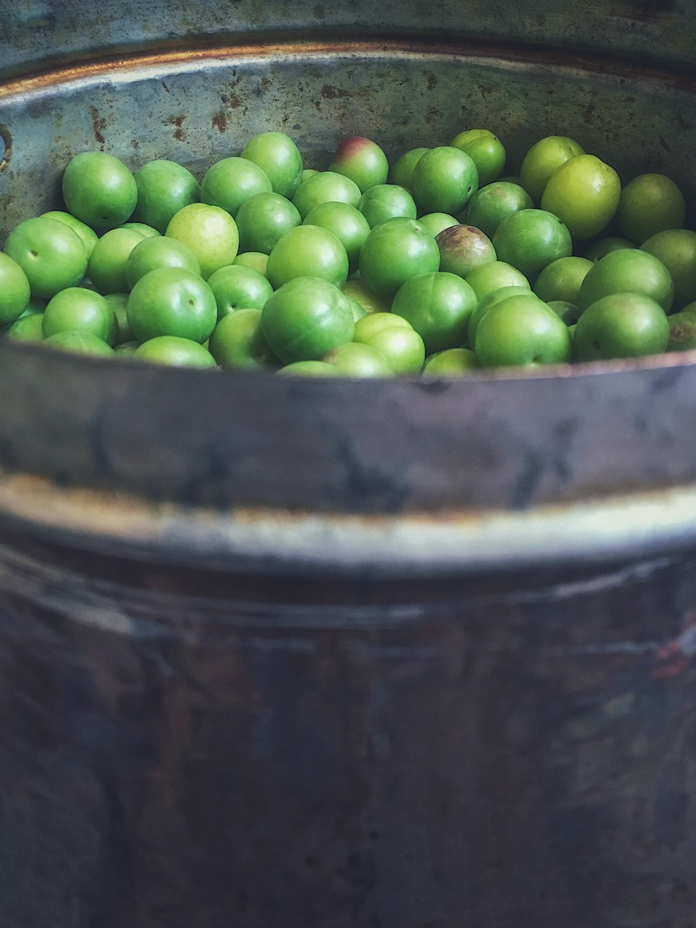 green fruits in barrel