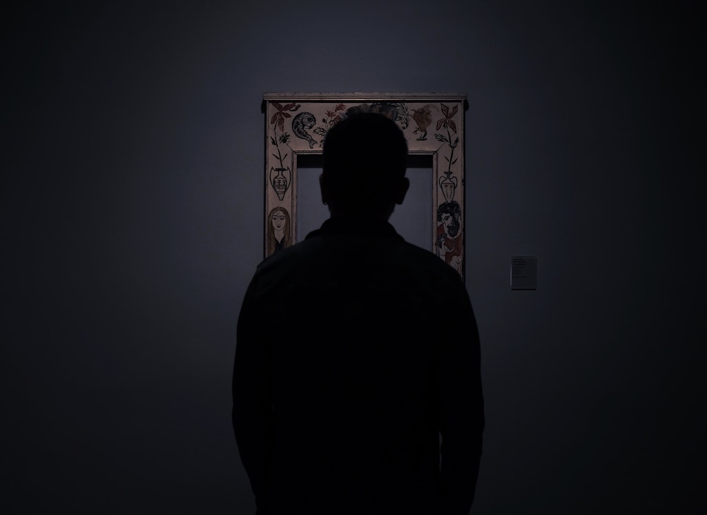 silhouette of person facing an empty photo frame