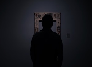 silhouette of person facing an empty photo frame